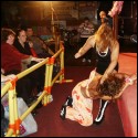 Phoenix viciously pounds away at Kiki Malaya...just a few feet away from some fans who are stunned by her actions.
