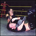 Simply Luscious uses a leg across her opponent's throat as she also tries to wrench his arm out of the shoulder!