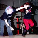 Sonya can be a bit vicious herself: here she is not only winding up her opponent's arm, but also jumping off the mat in an attempt to wrench the limb out of its socket!