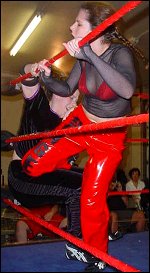 Allison Danger slams a knee into the stomach of Alicia. Although it was Alicia's very first singles match ever, Danger held back nothing in her attempt to punish the rookie.