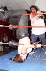 Lady Draven takes a beating as she's hung upside down in the corner during a mixed hardcore battle. Lady Draven takes a beating as she's hung upside down in the corner during a mixed hardcore battle.
