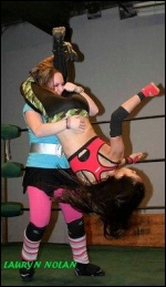 Roxie is about to hit the mat courtesy of a Miss April tilt-a-whirl head scissors.