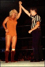 A common sight: The referee raises Penny's arm in victory! A common sight: The referee raises Penny's arm in victory!