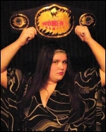 TNR holds her title belt high.