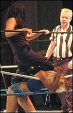 Wesna shows no mercy in the ring. Here she toys with her smaller blonde opponent as she chokes her over the middle ring rope.