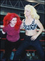Lady Vendetta prepares to send Sonya Blackhawk flying with a hiptoss off the ropes.