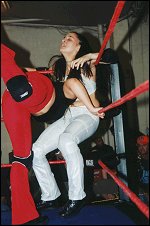 Phoenix takes advantage of the situation as she traps Ariel in the corner and drives a shoulder block into the belly of her defenseless opponent.