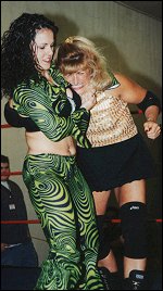 Tiffani Monroe grimaces in pain from a tight, skull-crushing side headlock.