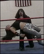 Ariel is nearly broken in two pieces by this devastating Hades backbreaker.