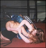 Dixie's submission hold is about to bring a screaming surrender from her opponent.