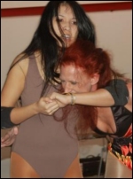 Su cranks a side headlock on archenemy Tasha Simone.