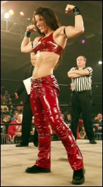 Trinity shows off "the guns" prior to a TNA match.